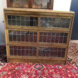 AN OAK THREE SECTION STACKING BOOKCASE