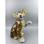 A CERAMIC MODEL OF A LEOPARD CUB