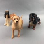 A BESWICK FIGURE OF A DACHSHUND AND TWO OTHER DOGS