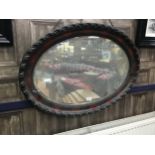 A 20TH CENTURY STAINED WOOD OVAL WALL MIRROR