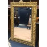 A GILTWOOD AND PLASTER RECTANGULAR WALL MIRROR