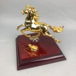 A 20TH CENTURY MALAYSIAN GILT SCULPTURE OF A GALLOPING HORSE