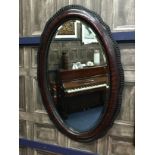 A STAINED WOOD WALL MIRROR