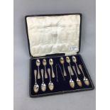 A SET OF TWELVE SILVER TEASPOONS AND SUGAR TONGS IN A FITTED CASE