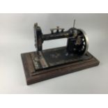 A 20TH CENTURY SEWING MACHINE IN WOOD CARRY CASE