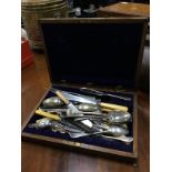 AN OAK CANTEEN OF SILVER PLATED CUTLERY AND OTHER FLATWARE