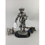 A SILVERED RESIN FIGURE OF A CAVALIER AND TWO CANNONS