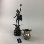 AN INDIAN WHITE METAL MILK JUG AND A SPELTER FIGURE
