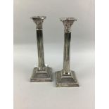 A PAIR OF SILVER PLATED WALKER & HALL COLUMN CANDLESTICKS