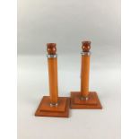 A PAIR OF ART DECO AMBER BAKELITE CANDLESTICKS