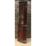 A REPRODUCTION MAHOGANY TWO STAGE CORNER CUPBOARD