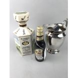 A SILVER PLATED WATER JUG ALONG WITH A DECANTER AND BOTTLE OF BEER