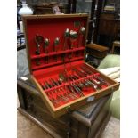 A CANTEEN OF BRASS CUTLERY ALONG WITH CANDLESTICKS, PLATES AND A PRINT