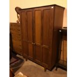 A STAINED WOOD TWO DOOR WARDROBE WITH MATCHING DRESSING CHEST