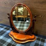 A VICTORIAN MAHOGANY OVAL DRESSING MIRROR