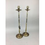 A PAIR OF TALL BRASS CANDLESTICKS AND TWO LAMPS