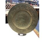 AN EARLY 20TH CENTURY CHINESE BRASS CIRCULAR PLAQUE