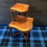 A HARDWOOD TWO TIER CORNER TABLE