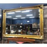 A GILT FRAMED WALL MIRROR