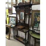 A LATE VICTORIAN CARVED OAK HALLSTAND