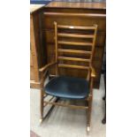 A STAINED WOOD LADDER BACK ROCKING CHAIR AND A WALNUT CHEST OF DRAWERS