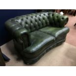 A GREEN LEATHER CHESTERFIELD SETTEE, WITH A MATCHING WING BACKED ARMCHAIR AND ANOTHER ARMCHAIR