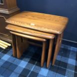 A NEST OF THREE ERCOL OAK OCCASIONAL TABLES