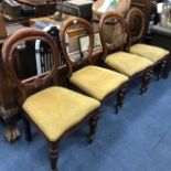 A SET OF FOUR VICTORIAN BALLOON BACK ARMCHAIRS