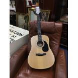 A STAINED WOOD ACOUSTIC GUITAR