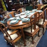 A CHINESE EXTENDING DINING TABLE WITH SIX CHAIRS