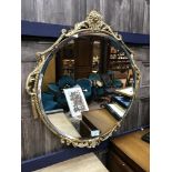 A GILT FRAMED CIRCULAR WALL MIRROR