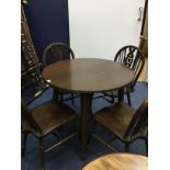 A STAINED WOOD CIRCULAR DINING TABLE AND FOUR CHAIRS