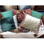 A GROUP OF FIVE CUSHIONS AND A ROLL OF TARTAN FABRIC