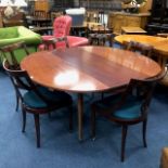 A MODERN MAHOGANY OVAL EXTENDING DINING TABLE AND SIX CHAIRS