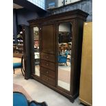 A MAHOGANY TRIPLE DOOR WARDROBE