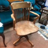 AN OAK OFFICE ARM CHAIR