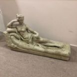 A GARDEN STATUE OF RECLINING FEMALE