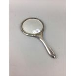A SILVER BACKED HAND MIRROR