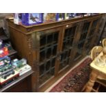 AN OAK FOUR DOOR BOOKCASE