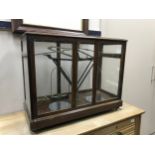 A VINTAGE SET OF SCALES IN A DISPLAY CASE