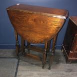 AN OAK DROP LEAF TABLE