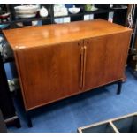 A RETRO TEAK DRINKS CABINET WITH AN INCOPORATED FRIDGE DESIGNED BY BERNADOTTE & BJORN