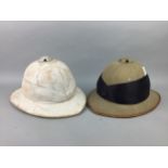 A LOT OF TWO VINTAGE PITH HELMETS, A BOWLER HAT, TROUSERS AND A COAT