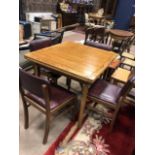 AN OAK TABLE AND FOUR CHAIRS