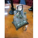 A SILVER PLATED AND GLASS SIX BOTTLE CRUET SET