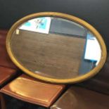 AN EARLY 20TH CENTURY GILT FRAMED OVAL WALL MIRROR