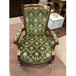 A VICTORIAN WALNUT ARMCHAIR