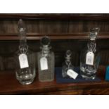 A LOT OF FOUR CRYSTAL AND GLASS DECANTERS WITH STOPPERS