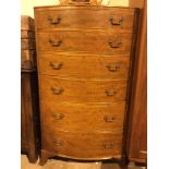 A REPRODUCTION MAHOGANY BOW FRONTED CHEST OF SIX DRAWERS