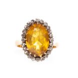 A YELLOW GEM SET AND DIAMOND RING